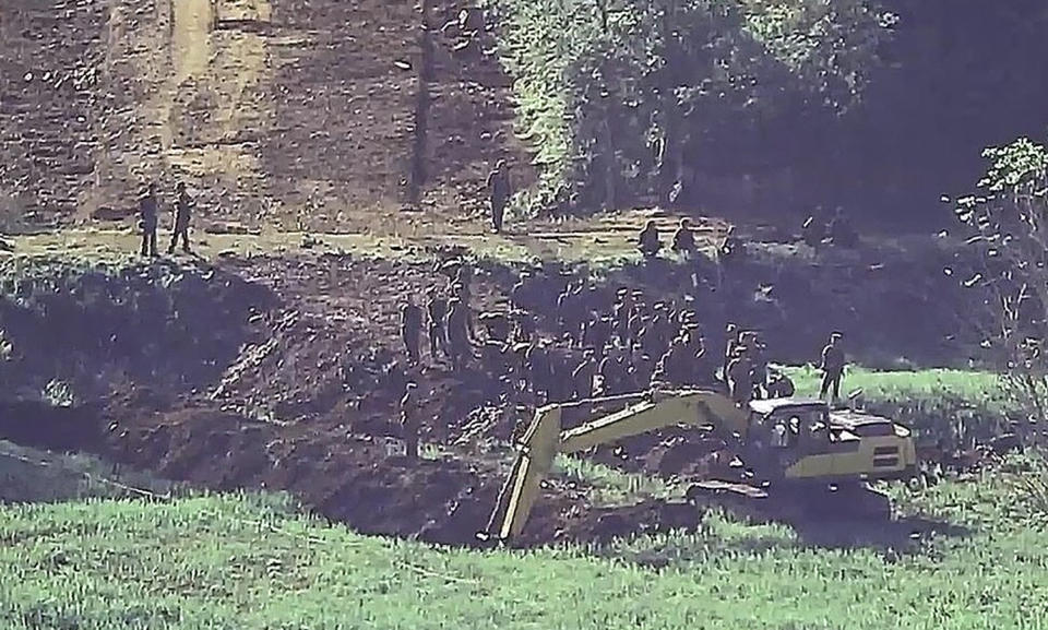 In this undated photo provided on Tuesday, June 18, 2024, by South Korea Defense Ministry, North Korean soldiers work at an undisclosed location near the border area, as seen from a South Korean guard area. South Korean soldiers fired warning shots to repel North Korean soldiers who temporarily crossed the rivals' land border Tuesday for the second time this month, South Korea's military said. (South Korea Defense Ministry via AP)