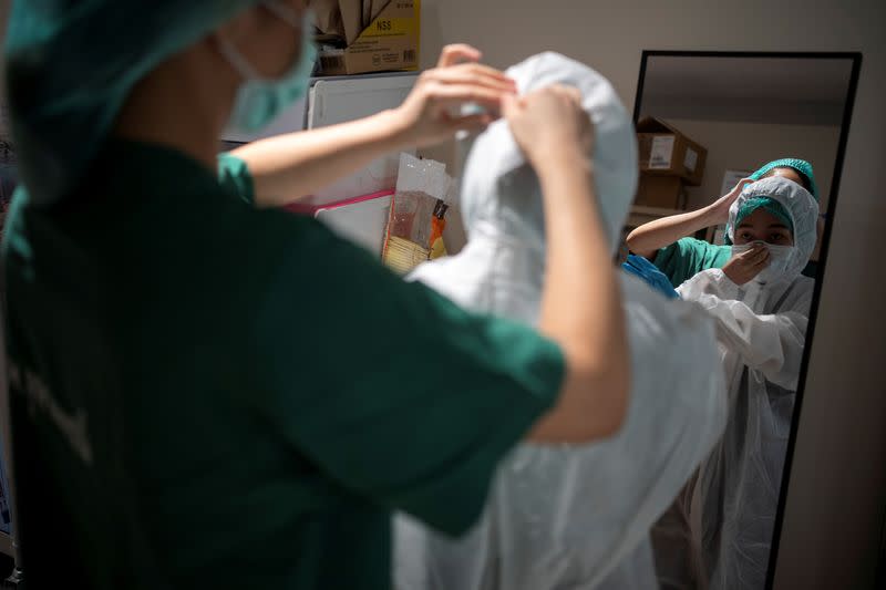 Medical workers take care of the coronavirus disease (COVID-19) patients in the ICU room in Bangkok