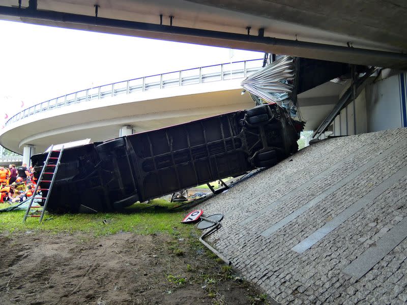 First responders attend to the scene of a public bus crash in Warsaw