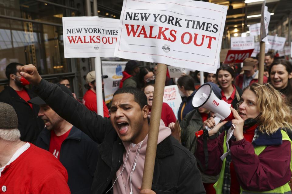 People chant slogans as they walk. Some carry signs.