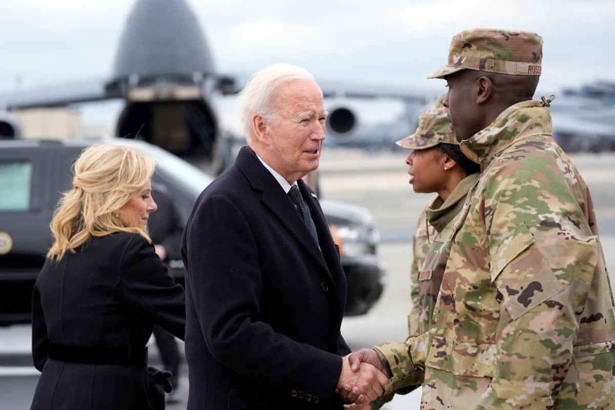 Joe Biden and first lady Jill Biden greet service members before boarding Air Force One  (AP)