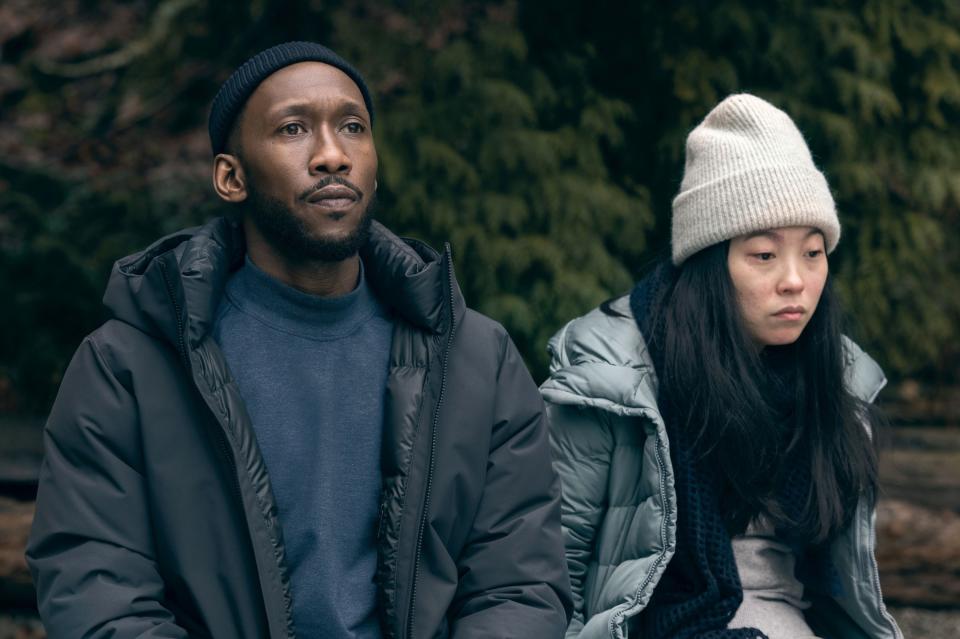 Mahershala Ali and Awkwafina sit with coats on