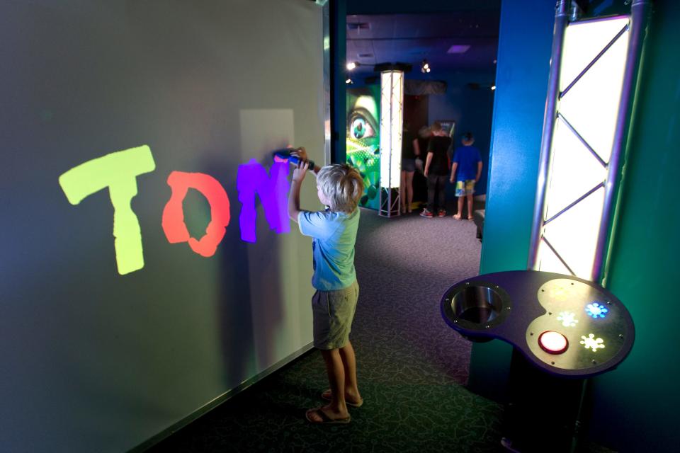 Kids can "paint" on the walls at MOSH's "Playing With Light."