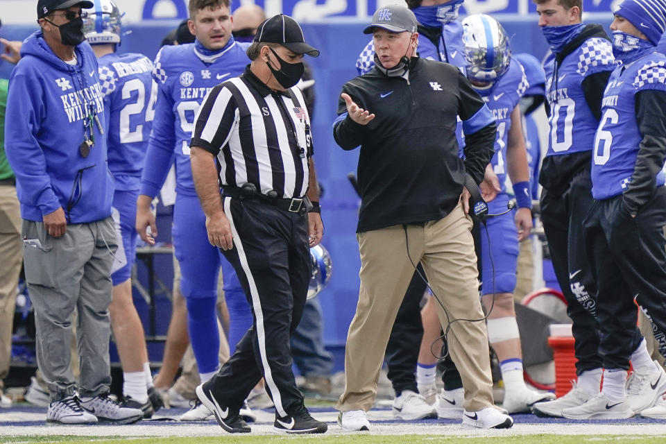 Kentucky head coach Mark Stoops speaks with an official during the first half of an NCAA college football game against Vanderbilt, Saturday, Nov. 14, 2020, in Lexington, Ky. (AP Photo/Bryan Woolston)