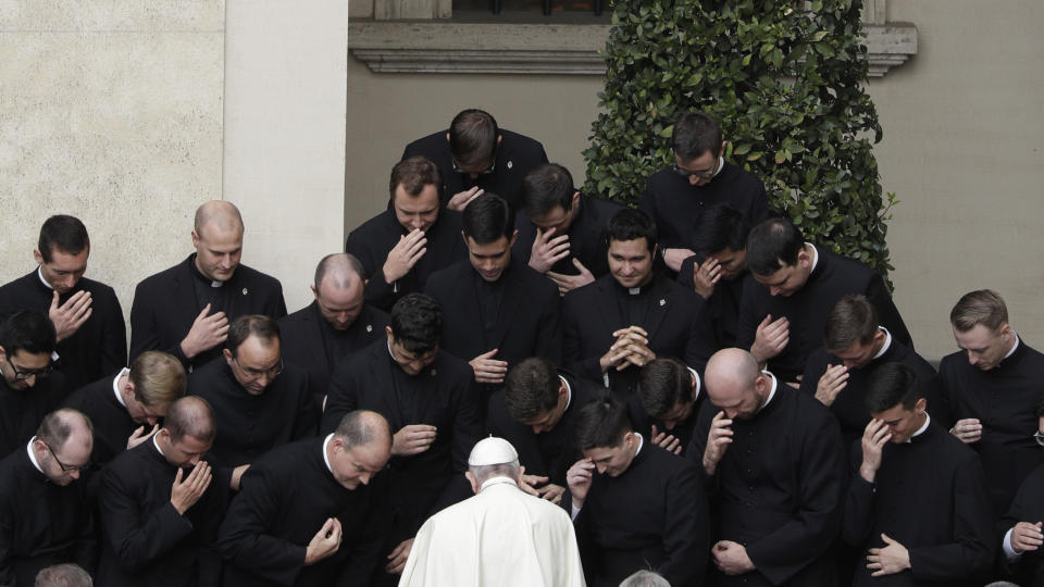 A group of seminarians make the signs of the cross as they are greeted by Pope Francis during his weekly general audience in the St. Damaso courtyard at the Vatican, Wednesday, Sept. 30, 2020. (AP Photo/Gregorio Borgia)