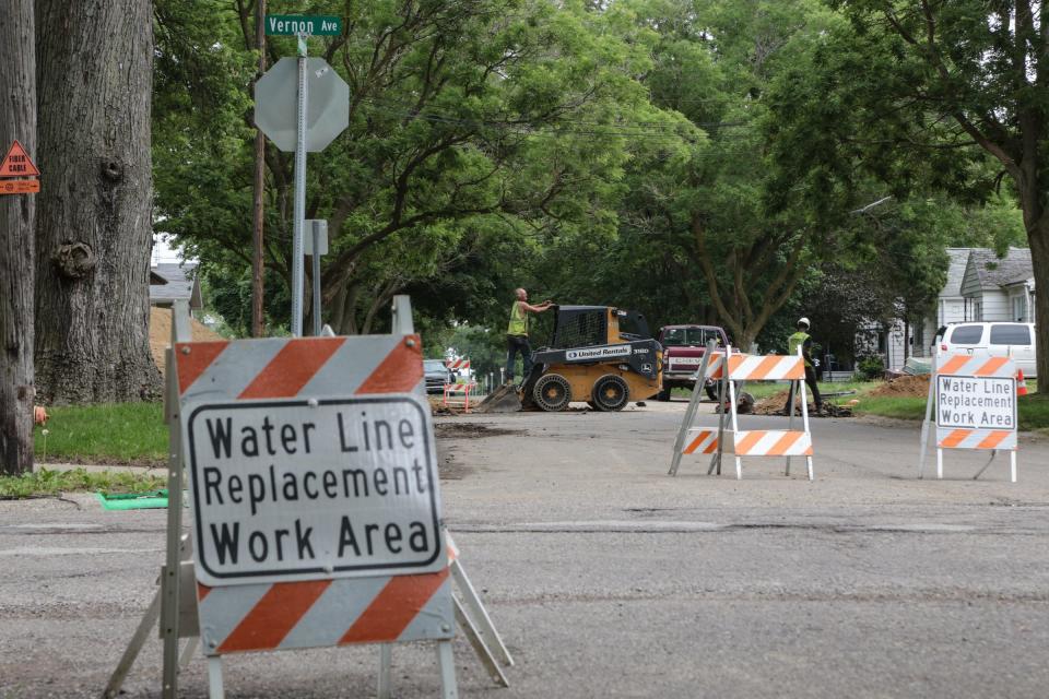 Signs for water line replacement are seen as crews work near Vernon Ave .and Kentucky Ave. in Flint's east side on June 14, 2017.
