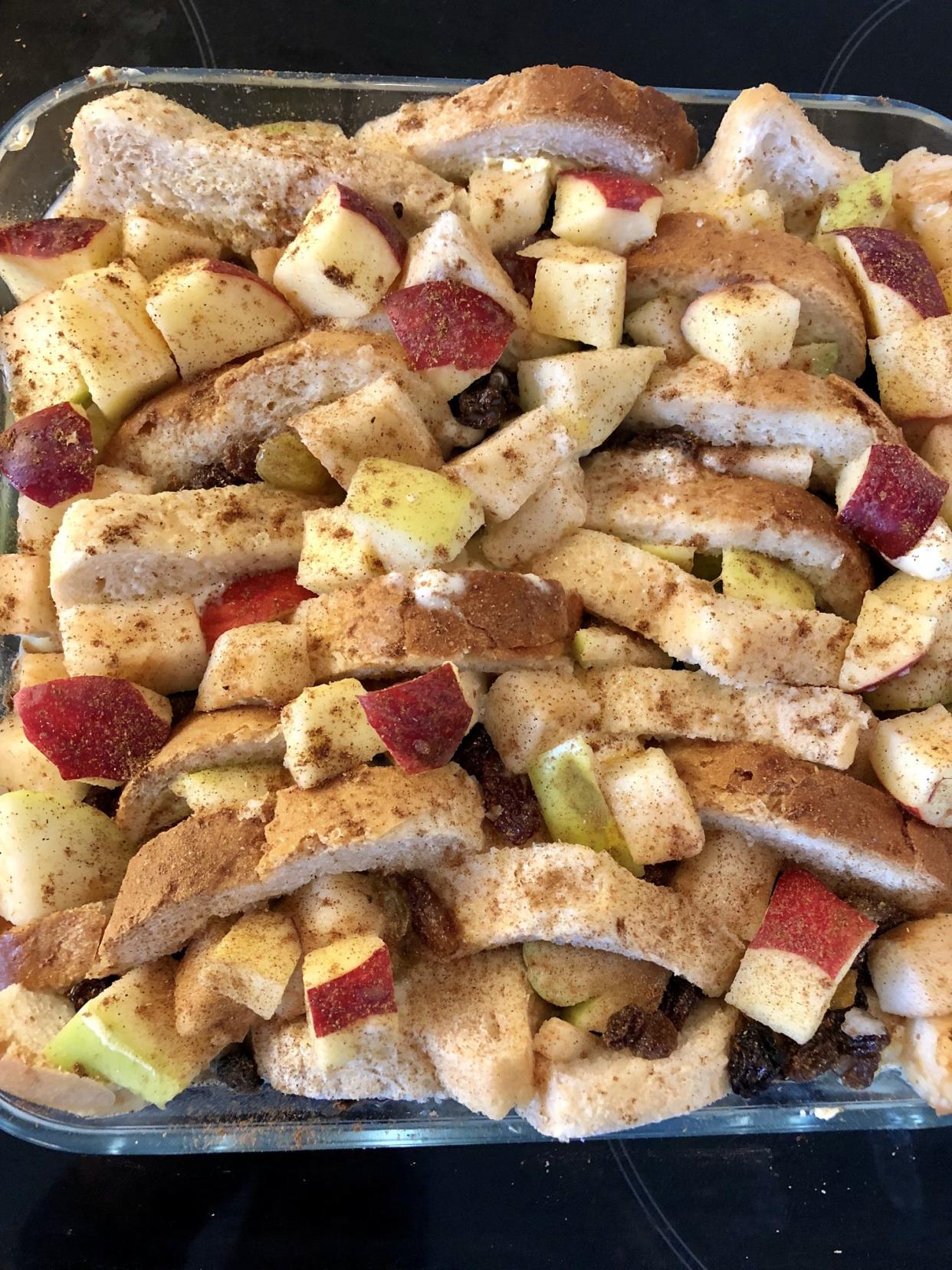 Stock image showing the ingredients for a bread and butter pudding in a glass baking dish ready for the oven.