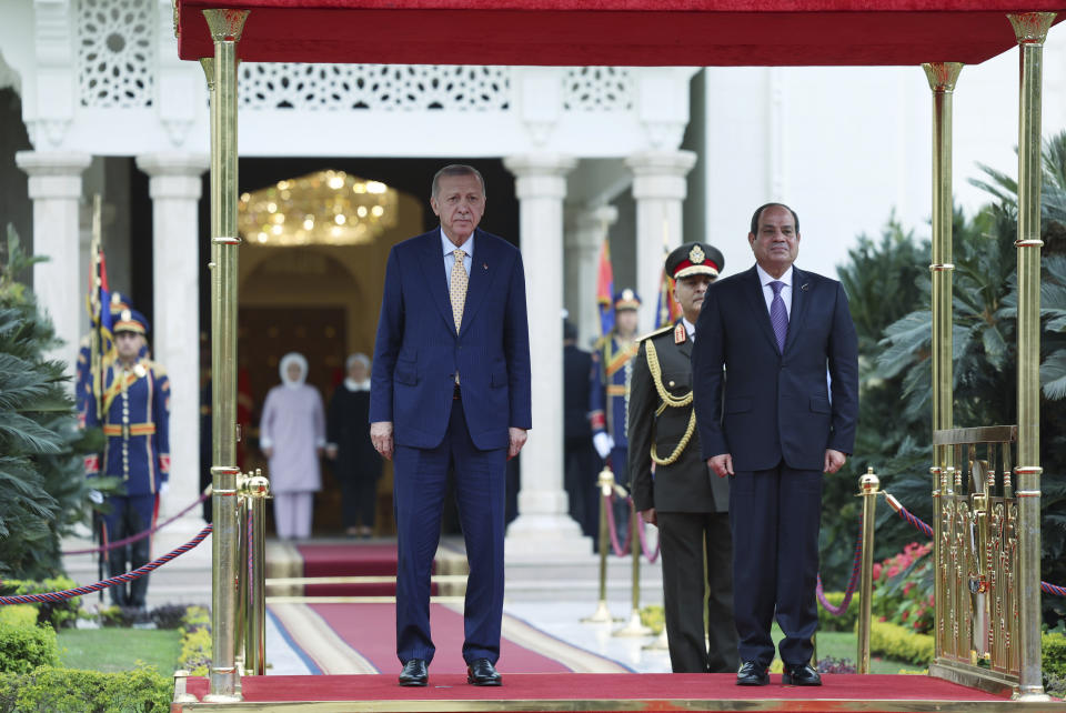 In this handout photo released by Turkish Presidency, Turkey's President Recep Tayyip Erdogan, left, Egyptian President Abdel Fattah Al-Sissi listen to national anthems during a welcome ceremony at Al-Ittihadiya palace in Cairo, Egypt, Wednesday, Feb. 14, 2024. (Turkish Presidency via AP)