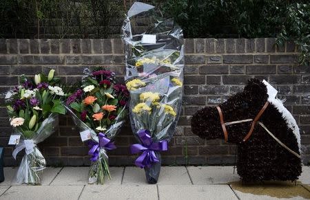Floral tributes are left for Anthony Disson, a victim of the Grenfell tower fire, ahead of his funeral in London, Britain, June 29, 2017. REUTERS/Hannah McKay/Files