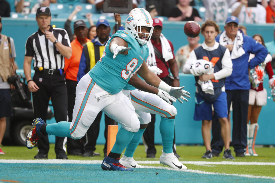 Miami Dolphins defensive tackle Christian Wilkins (94) goes after the football after the fumbles and recovered it for a touchdown, during the first half at an NFL football game ab=, Sunday, Dec. 22, 2019, in Miami Gardens, Fla. (AP Photo/Wilfredo Lee)