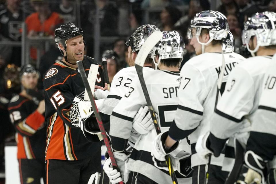 Ducks captain Ryan Getzlaf, left, is greeted by members of the Kings.