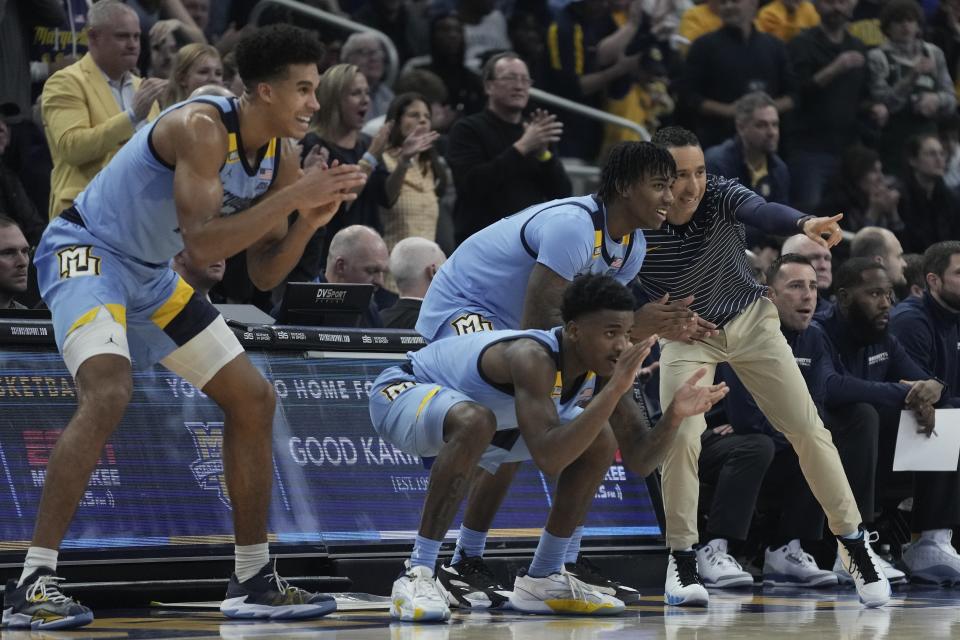 Marquette head coach Shaka Smart and players celebrate during the first half of an NCAA college basketball game against Georgetown Friday, Dec. 22, 2023, in Milwaukee. (AP Photo/Morry Gash)