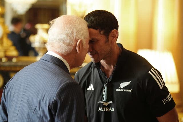 Charles performs a hongi - a traditional Maori greeting - with team manager Allan Bunting 