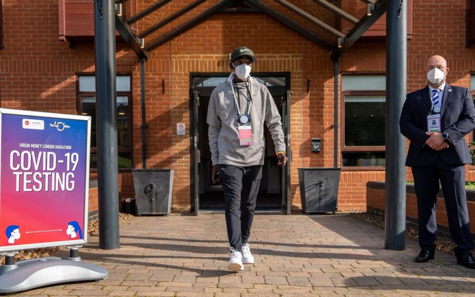 Kenya's Eliud Kipchoge walks out of the COVID-19 testing area after arriving at the official hotel  - PA