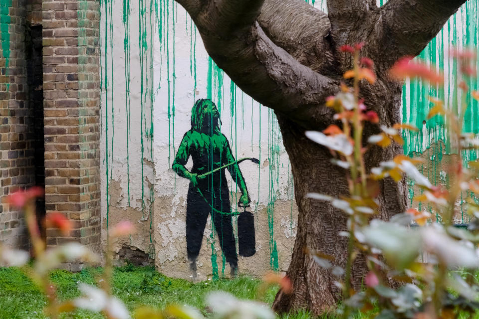 LONDON, UNITED KINGDOM - MAR 18, 2024 - A 'Banksy' artwork framed by a tree, on the side of a building in north London. (Photo credit should read Matthew Chattle/Future Publishing via Getty Images)
