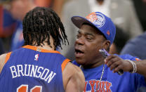 New York Knicks guard Jalen Brunson, left, hugs actor Tracy Morgan after the Knicks beat the Chicago Bulls in overtime in an NBA basketball game Sunday, April 14, 2024, in New York. (AP Photo/John Munson)