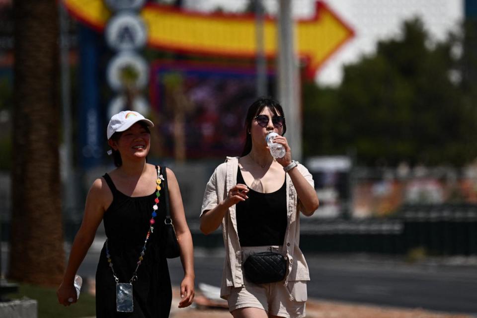 PHOTO: A person drinks a bottle of water while walking in the heat in Las Vegas, on July 30, 2023, as temperatures reach more than 100 degrees Fahrenheit (37.78C).  (Patrick T. Fallon/AFP via Getty Images, FILE)