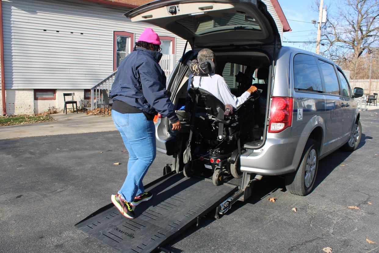 69-year-old Jewel Currie is helped into a transit van before an appointment on Thursday, Nov. 30.