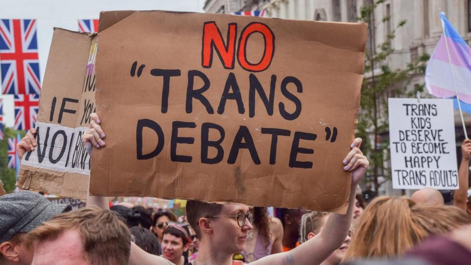 PHOTO: A protester holds a 'No trans debate' placard during the demonstration in Piccadilly Circus. Thousands of people marched through central London during Trans Pride 2023. (Vuk Valcic/SOPA Images/LightRocket via Getty Images)