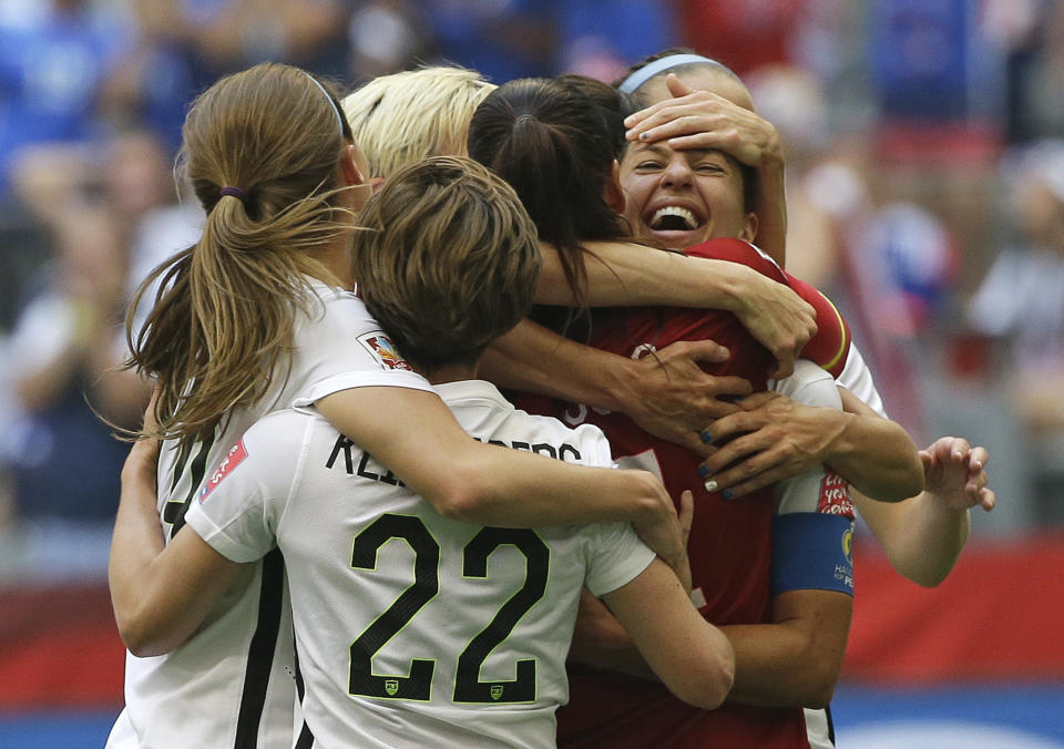 FILE - In this July 5, 2015, file photo, United States' Carli Lloyd, right, celebrates with teammates after Lloyd scored her third goal against Japan during the first half of the FIFA Women's World Cup soccer championship in Vancouver, British Columbia, Canada, Sunday, July 5, 2015. The U.S. national team, ranked No. 1 globally, will try to defend its title in soccer’s premier tournament, which kicks off on June 7. (AP Photo/Elaine Thompson, File)