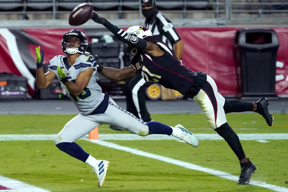 Seattle Seahawks wide receiver Tyler Lockett, left, pulls in a touchdown catch as Arizona Cardinals cornerback Patrick Peterson defends during the first half of an NFL football game, Sunday, Oct. 25, 2020, in Glendale, Ariz. (AP Photo/Rick Scuteri)