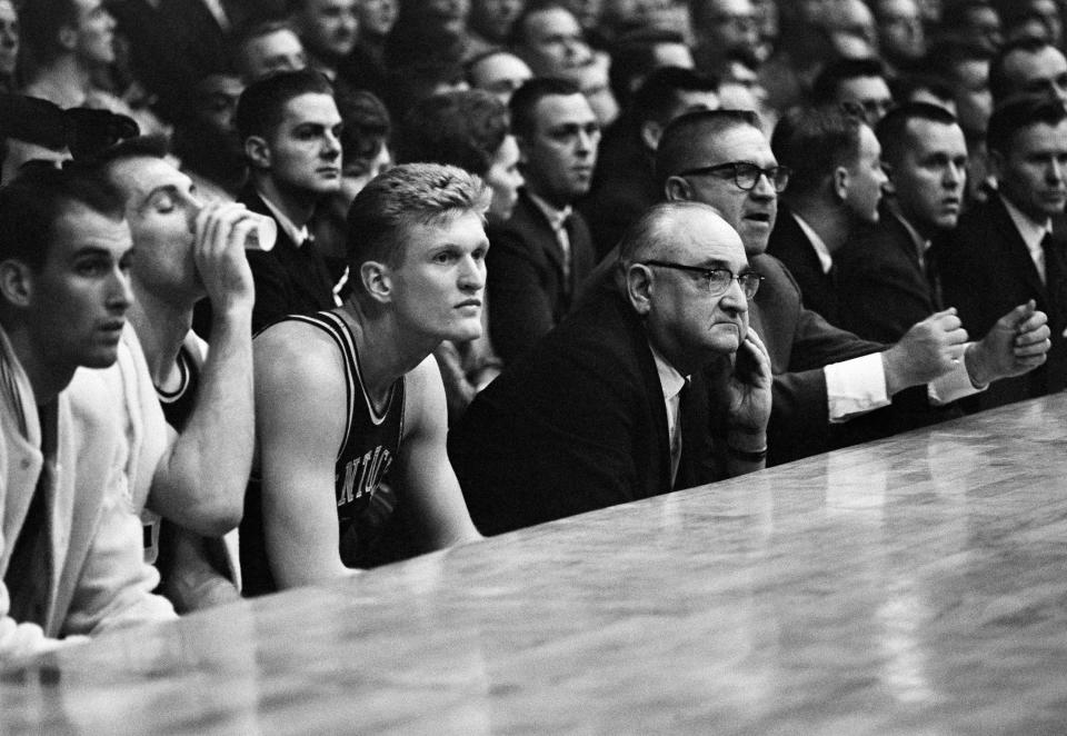 Adolph Rupp, middle, turned Kentucky basketball into a national power, winning four national championships. (AP)