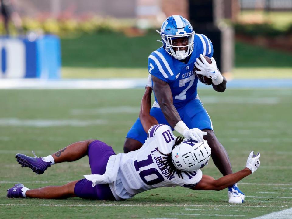 Duke’s Jordan Waters runs the ball under pressure from Northwestern’s Theran Johnson during the second half of the Blue Devils’ 38-14 win on Saturday, Sept. 16, 2023, at Wallace Wade Stadium in Durham, N.C. Kaitlin McKeown/kmckeown@newsobserver.com