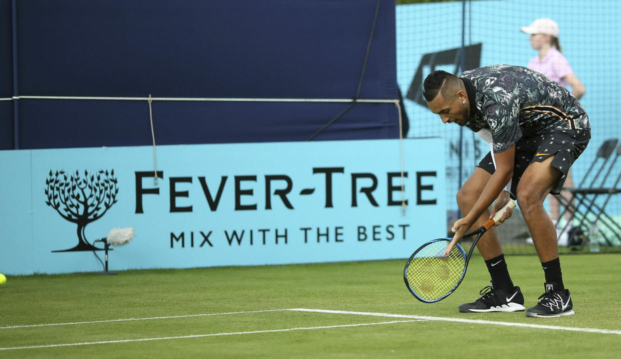 Australia's Nick Kyrgios appeals to the umpire on court one during his tennis match against Spain's Roberto Carballes Baena day four of the Fever-Tree Championship at the Queen's Club, London. Kyrgios swore at officials and accused them of "rigging" his first-round match at the Queen’s Club grass-court tournament in the latest outburst by one of tennis’ most unruly players. The outspoken Australian launched an expletive-ridden rant at umpire Fergus Murphy after missing a set point against Roberto Carballes Baena. (Steven Paston/PA via AP)