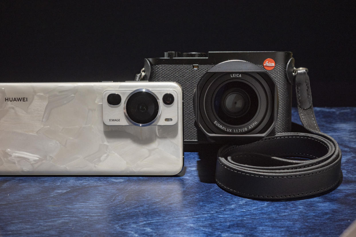  Huawei P60 Pro and Leica Q3 side by side on a blue table 