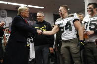 President Donald Trump shakes hands with Army player Cole Christiansen in Philadelphia, Saturday, Dec. 14, 2019, before the Army-Navy college football game. (AP Photo/Jacquelyn Martin)