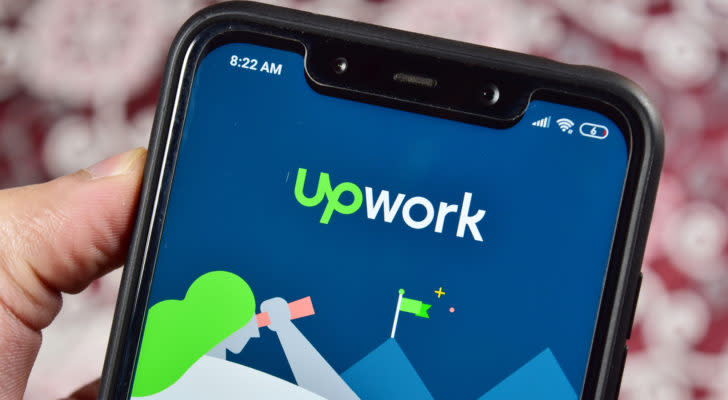 The logo for Upwork (UPWK) is displayed on a cellphone.