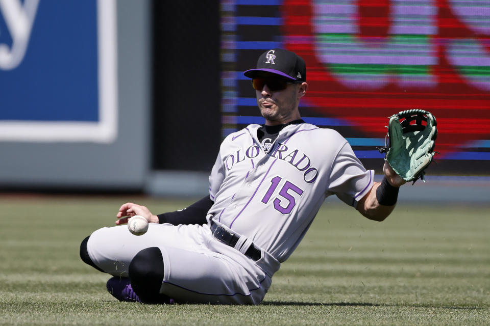 Colorado Rockies right fielder Randal Grichuk slides as he fields a single by Kansas City Royals batter Salvador Perez during the first inning of a baseball game in Kansas City, Mo., Saturday, June 3, 2023. (AP Photo/Colin E. Braley)