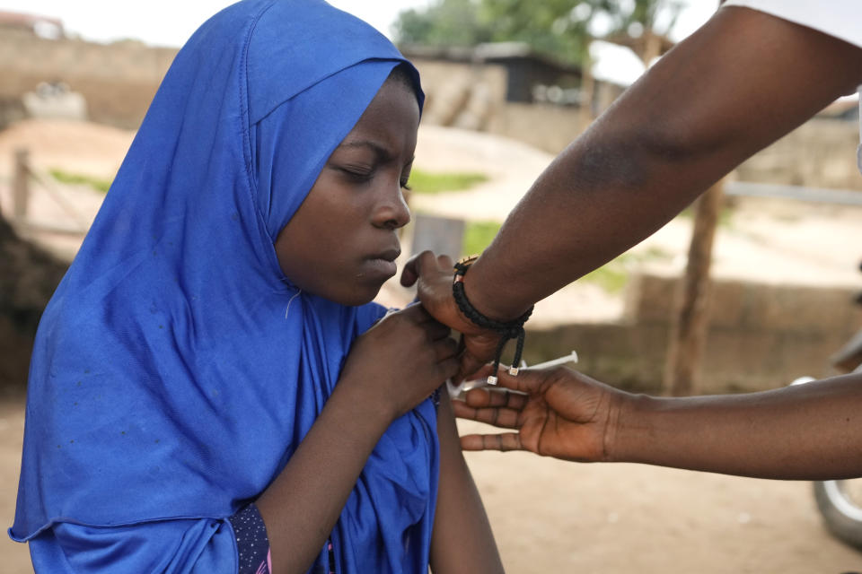 A health worker administers a cervical cancer vaccine HPV Gardasil to a girl on the street in Ibadan, Nigeria, on May 27, 2024. African countries have some of the world's highest rates of cervical cancer. Growing efforts to vaccinate more young girls for the human papillomavirus are challenged by the kind of vaccine hesitancy seen for some other diseases. Misinformation can include mistaken rumors that girls won't be able to have children in the future. Some religious communities must be told that the vaccine is "not ungodly." More than half of Africa's 54 nations – 28 – have introduced the vaccine in their immunization programs, but only five have reached the 90% coverage that the continent hopes to achieve by 2030. (AP Photo/Sunday Alamba)