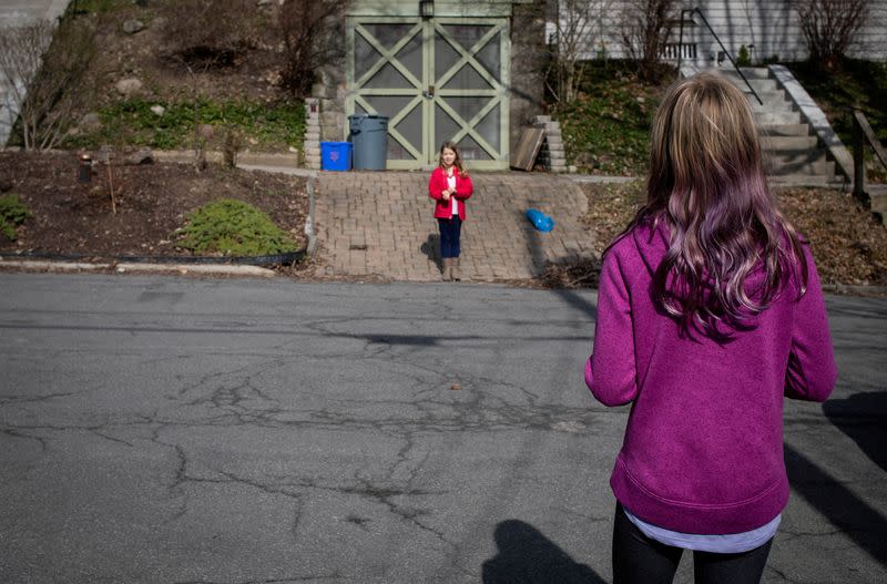 Friends and neighbors talk about their weekends from opposite sides of the road