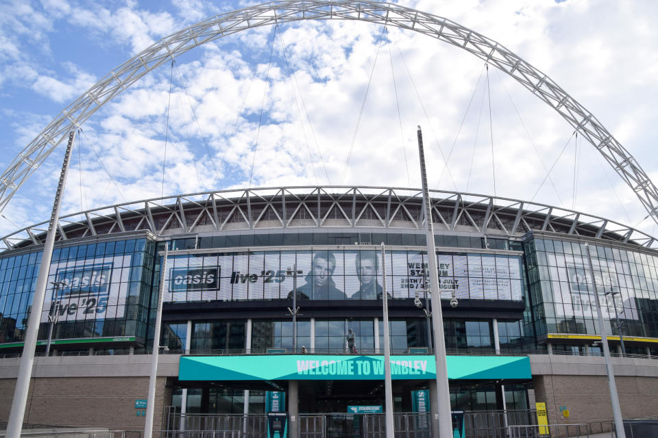 Screens at Wembley Stadium advertise upcoming Oasis performances