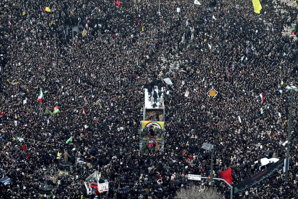 Coffins of Gen. Qassem Soleimani and others who were killed in Iraq by a U.S. drone strike, are carried on a truck surrounded by mourners during a funeral procession, in the city of Mashhad, Iran, Sunday, Jan. 5, 2020. Soleimani's death Friday in Iraq further heightens tensions between Tehran and Washington after months of trading attacks and threats that put the wider Middle East on edge. (Mohammad Hossein Thaghi/Tasnim News Agency via AP)