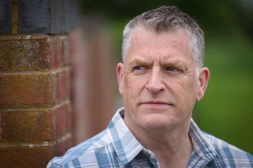 Paul Ridley, 59, pictured at home in Barrow-upon-Trent in Derbyshire wearing a white and blue patterned shirt