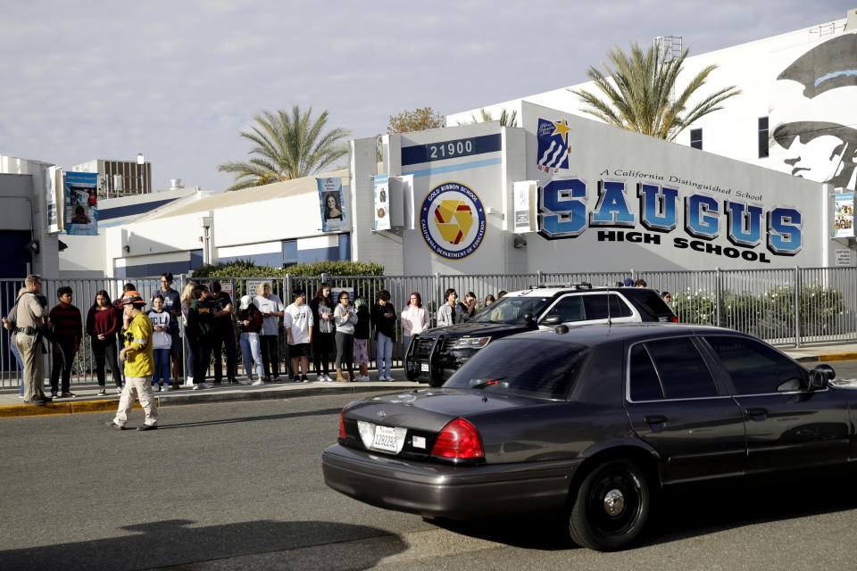 Students stand outside of Saugus High School after reports of a shooting on Thursday, Nov. 14, 2019, in Santa Clarita, Calif. (AP Photo/Marcio Jose Sanchez)