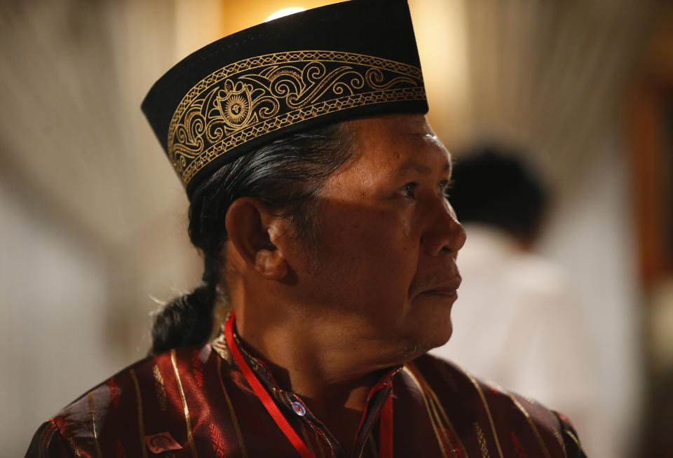 Abdullah Macapaar, who uses the nom de guerre Commander Bravo, waits for the oath-taking ceremony for the creation of the Bangsamoro Transition Authority or BTA at the Presidential Palace in Manila, Philippines Friday, Feb. 22, 2019. Some of the fiercest Muslim rebel commanders in the southern Philippines are in Manila to be sworn in as administrators of a new Muslim autonomy region in a delicate milestone to settle one of Asia's longest-raging rebellions. Several commanders, including Commander Bravo, long wanted for deadly attacks were given safety passes to be able to travel to Manila and join the ceremony. (AP Photo/Bullit Marquez)