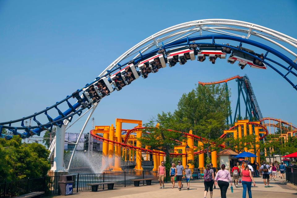 Cedar Point's classic Corkscrew roller coaster soars over the midway.