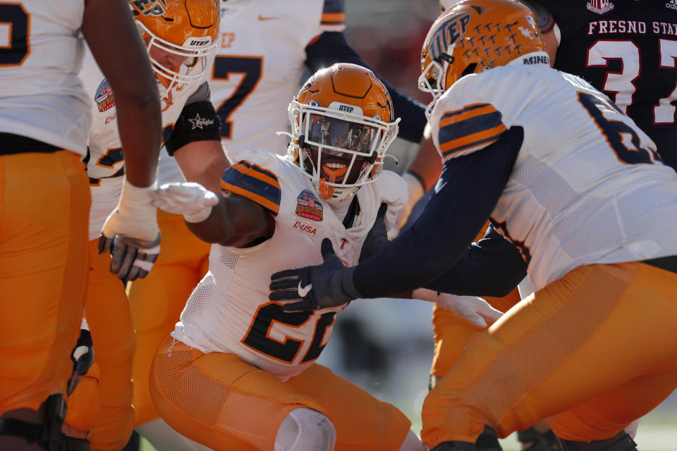 UTEP running back Ronald Awatt, center, celebrates with teammates after scoring a touchdown against Fresno State during the first half of the New Mexico Bowl NCAA college football game Saturday, Dec. 18, 2021, in Albuquerque, N.M. (AP Photo/Andres Leighton)