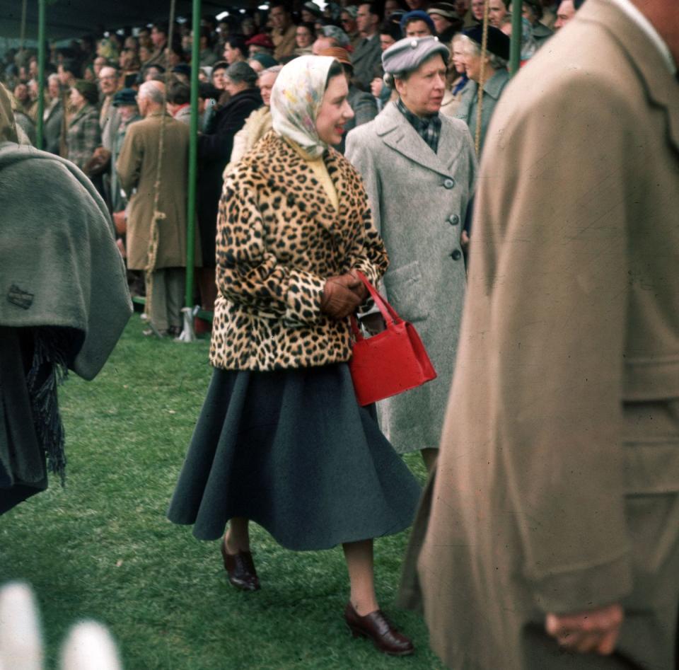 <p>The Princess dons a leopard coat at the Badminton Horse Trials with Mary, the Princess Royal in 1957. </p>