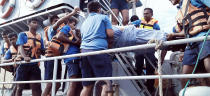 In this photo provided by Sri Lanka Navy, an injured crew member of the MT New Diamond, is transferred on stretcher to a navy vessel Thursday, Sept. 3, 2020, off Sangamankanda Point, Sri Lanka. A flotilla from Sri Lanka and India was escalating efforts to douse a fire raging on the oil tanker east of Sri Lanka for a second day Friday. The fire started Thursday in an engine room boiler on the MT New Diamond, leaving one crew member injured and one missing.(Sri Lanka Navy via AP)