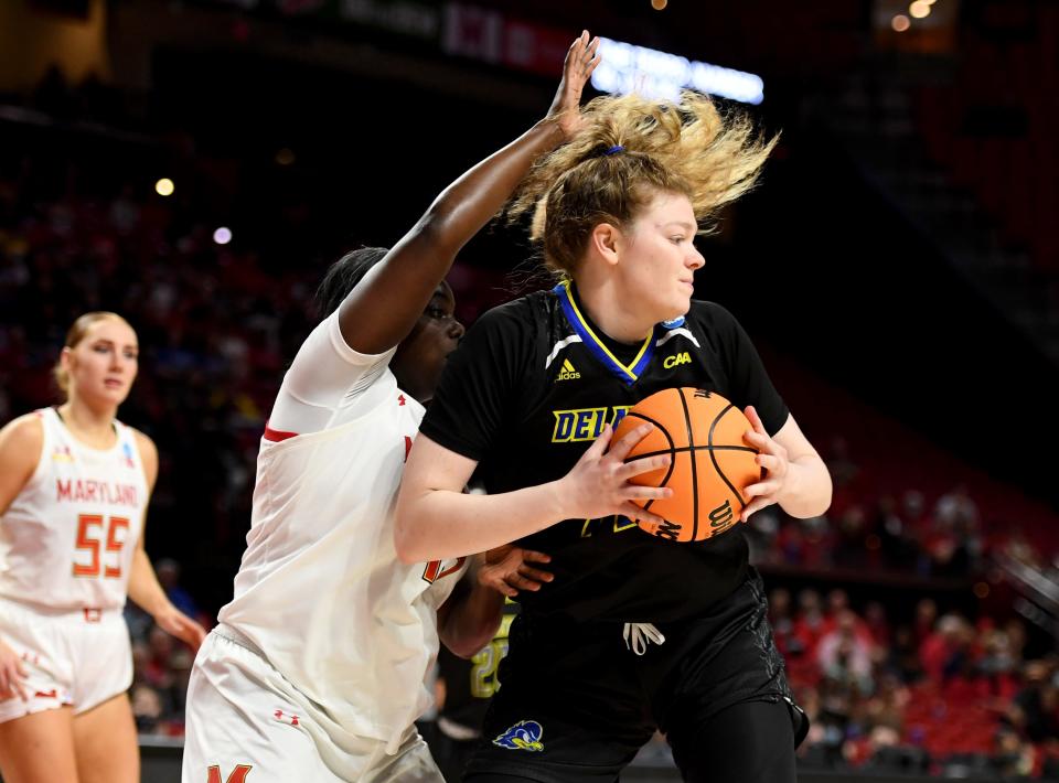 Delaware's LizzieOleary (12) turns away from Maryland's Ashley Owusu (15) Friday, March 18, 2022, at the University of Maryland Xfinity Center in College Park, Maryland.