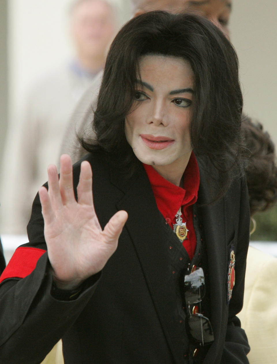 Pop star Michael Jackson waves to fans on leaving the Santa Barbara Superior County Court, in Santa Maria. Jurors in Jackson’s child molestation trial heard Thursday fingerprint analysis of adult magazines found in his home was not completed until long after they were seized. Jackson is accused of molesting a boy at his Neverland ranch in 2003. (Photo by Kimberly White/Corbis via Getty Images)