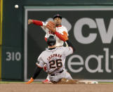 Boston Red Sox second baseman Enmanuel Valdez tags out San Francisco Giants' Matt Chapman (26) for the first out of a double play throwing to first during the ninth inning of a baseball game against the San Francisco Giants, Wednesday, May 1, 2024, in Boston. (AP Photo/Mark Stockwell)