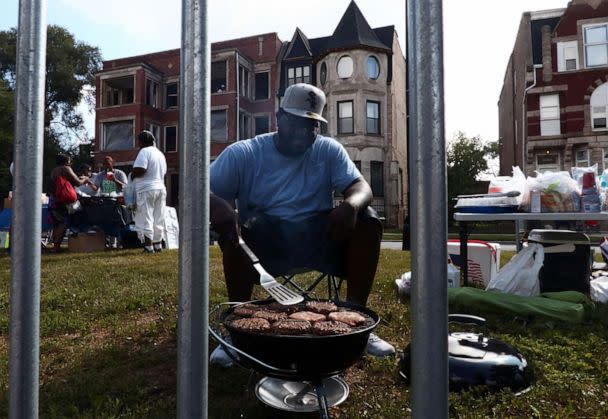 PHOTO: A man cooks hamburgers on a grill along the parade route during the 87th 'Bud Billiken Parade' in Chicago, on Aug. 13, 2016.   (Bilgin S. Sasmaz/Anadolu Agency via Getty Images)