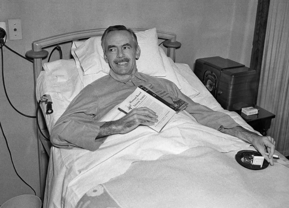 FILE - In this Jan. 11, 1937 file photo, Eugene O'Neil, playwright and winner of the Nobel Prize, holds a book and a cigarette in his hospital bed in Oakland, Calif. during his first interview since being stricken with appendicitis. (AP Photo/RJF)