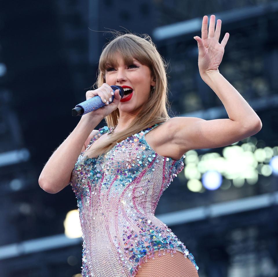 Taylor Swift performs on stage in a sparkling bodysuit