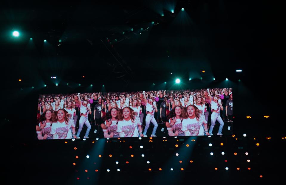 Fans of the Jonas Brothers are projected onto the screen above the stage as the band plays at Bridgestone Arena in Nashville, Tenn., Monday, Oct. 9, 2023.